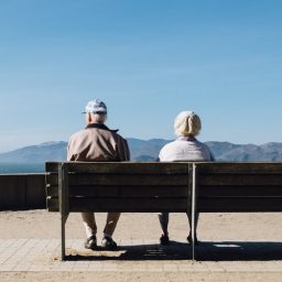 Two seniors sitting on a bench