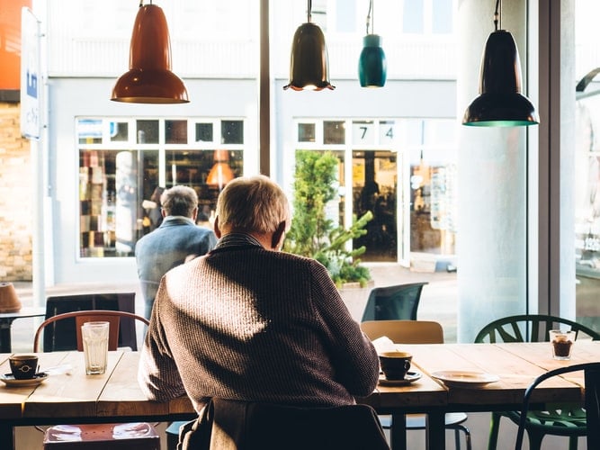 Man sits inside of a coffee shop