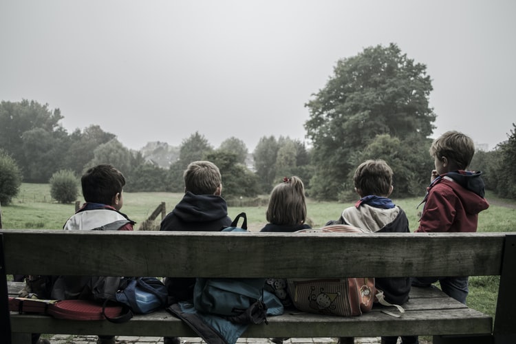 Children socializing on a bench.