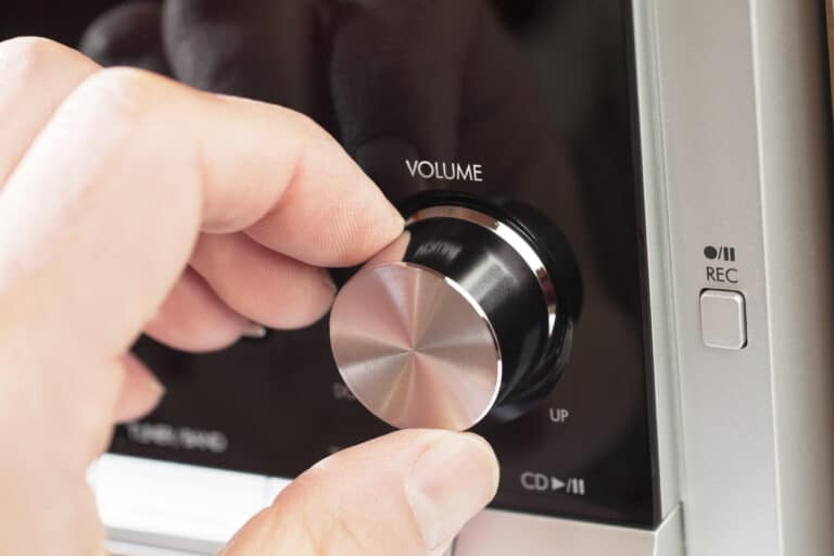 Turning the volume knob on a hi fi Adjusting the volume