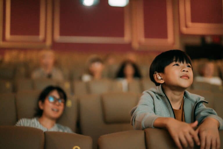 Boy with hearing aid sees a movie Boy with hearing aid sees a movie
